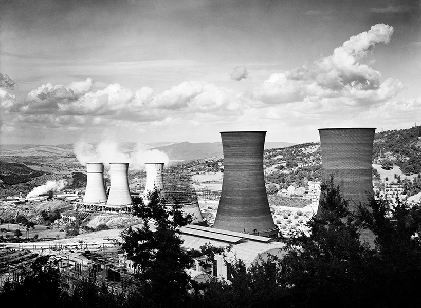 Lardarello geothermal power plant Black and white photo of bucolic landscape studded with large industrial cooling towers.