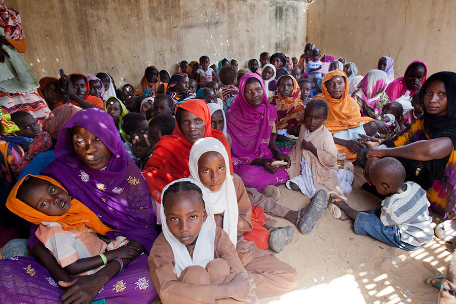 Access A room full of women and children wait to be vaccinated against meningitis in a refugee camp in Darfur.