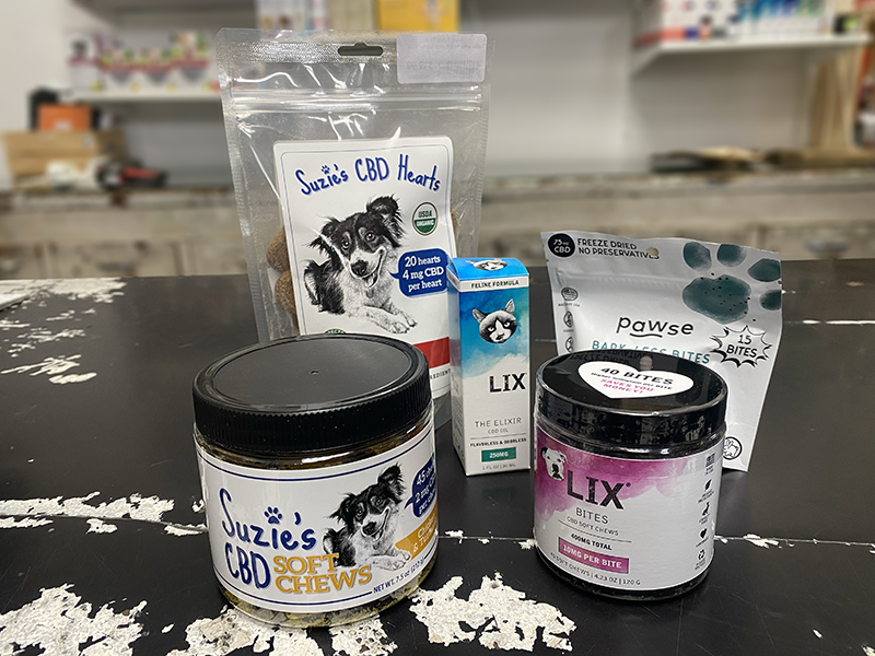 CBD products Jar and packages of CBD chews and elixirs on a store counter.